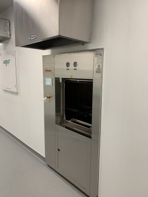 Wall-recessed Tuttnauer 66E double-door sterilizer in clean production room at Optimi Health Princeton BC