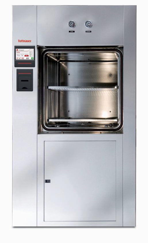 Front view of Tuttnauer 66 Series autoclave with open vertical sliding door, two chamber shelves and BacSoft controller